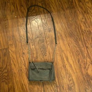 A dark gray purse with 3 pockets